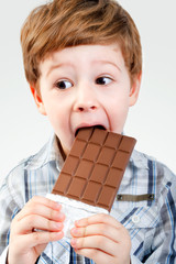 Close Up of Young Boy Eating A chocolate bar