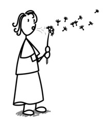 Fillette soufflant sur une fleur de pissenlit