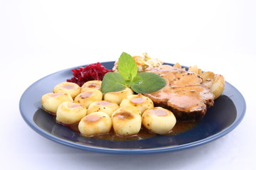 Pork steak and dumplings with side salads and a mint twig