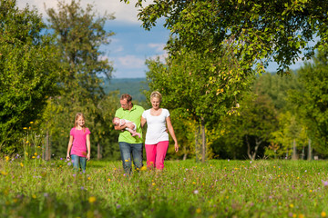 Obraz premium Family with kids having walk in summer