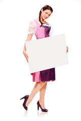 Beautiful young girl with dirndl dress holding white board