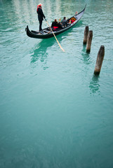 Fototapeta na wymiar Romatic cruise in gondola in the canal of Venice