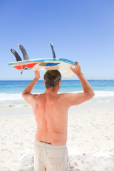 Retired man with his surfboard