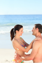 Adorable couple huging on the beach