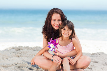 Little girl and her mother with a windmill