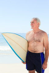 Retired  man with his surfboard