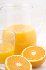 orange juice with half fruits isolated on white