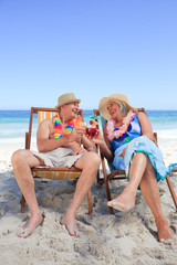 Mature couple sitting on deck chairs