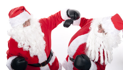 Two santa claus on white background are boxing