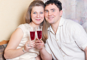 The man and the woman with glasses of wine