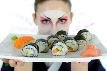 beautiful japan geisha woman with creative make-up and sushi ro