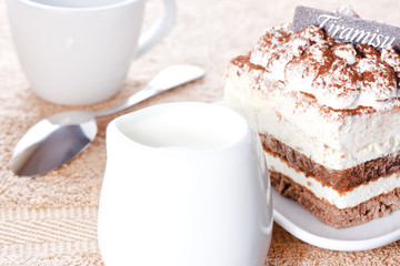 Portion of tiramisu dessert and a cup of coffee