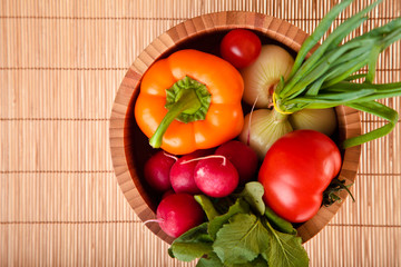 Different ripe vegetables compositions in studio on bamboo