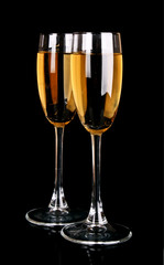 Glasses with champagne on black background
