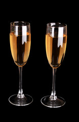 Glasses with champagne on black background