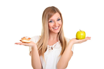 Woman choosing apple over puff cookie isolated on white