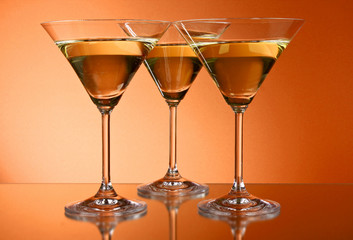 Three martini glasses on yellow background