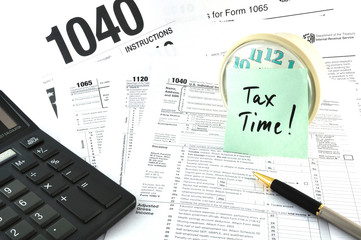 Tax Time. The Concept Image with a calculator and  a clock.