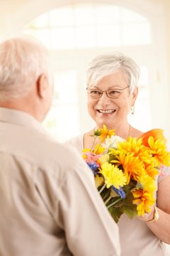 Happy Elderly Lady Receiving Flowers