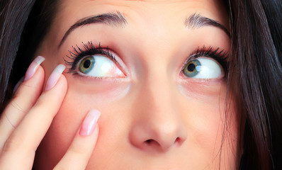 Fototapeta premium Closeup portrait of a pretty young woman touching her face