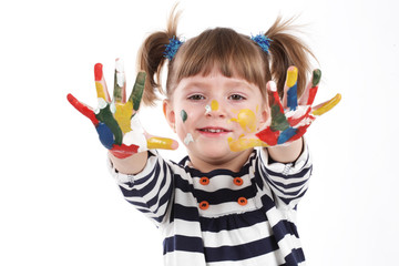 four-year girl with hands soiled in a paint.