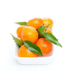 Tangerines with leaves isolated over white