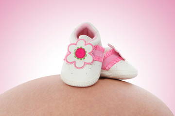 Baby Shoes on Pregnant Woman
