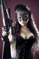 Masked beautiful asian woman with rifle