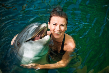 Girl hugging a dolphin in the water
