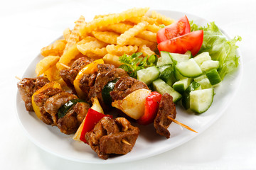 Grilled meat, French fries and vegetables