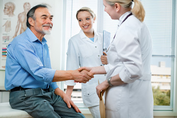 doctor shakes hands with a patient