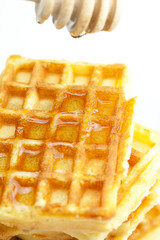 delicious Belgian waffles and stick to honey isolated on white