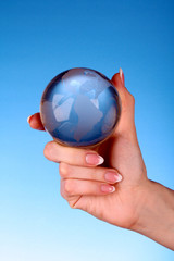 Crystal ball on hand. blue background