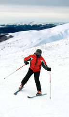 Skier man in snow-covered mountains