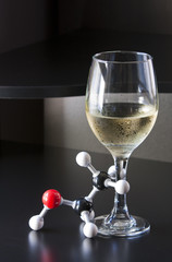 "Tipsy" ethanol molecule and a glass of wine
