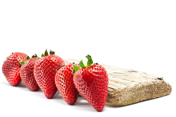 group of strawberries over a piece of old wood