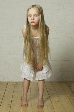 Teen girl fashion model with blond hair and red lips