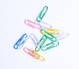 Isolated mixed colored paperclips on white background