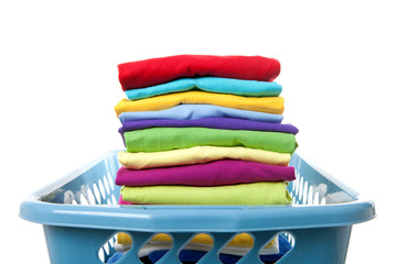 Laundry basket with folded clothes over white background