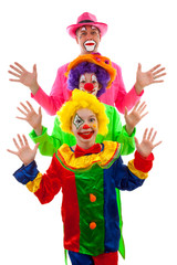 Three people dressed up as colorful funny clown