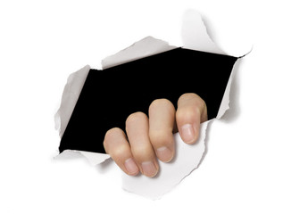 Hand tearing through white paper. Break out!