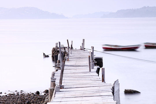 Fototapeta Jetty sunset along a wooden pier