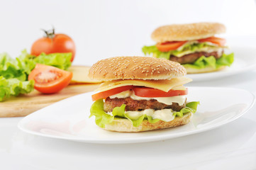 hamburger and vegetables on white