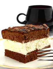 A slice of chocolate cake with white cream inside