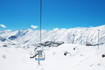 Ski lift chairs on bright winter day