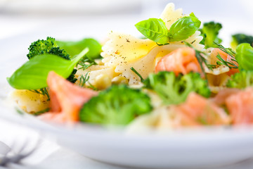 Closeup of gourmet pasta salad with salmon and herbs