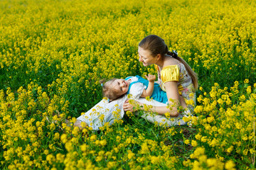 Fototapeta premium mother with baby on yellow field