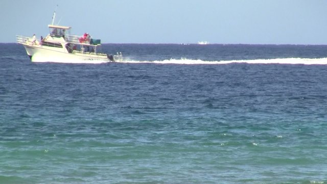 Boat Crossing The Ocean Horizon