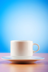 White cup against colourful gradient on the table