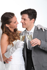 Bride and groom drinking champagne